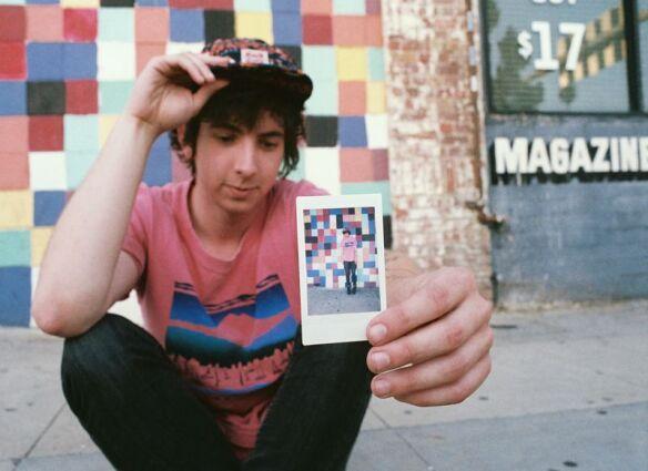 Trevor holding a Polaroid