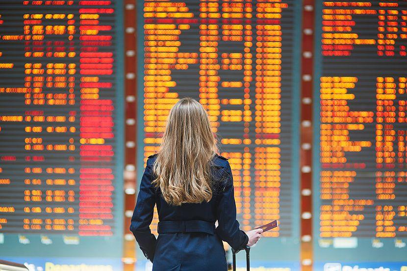 Girl stands at departure board