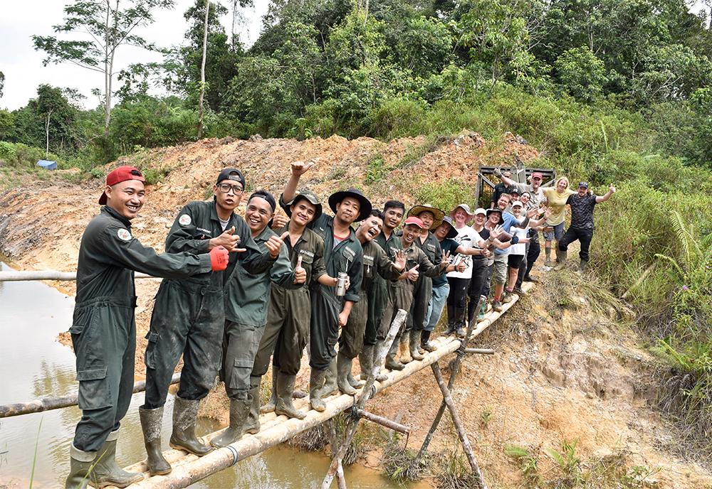 Volunteers and staff on bamboo bridge at Samboja Lestari