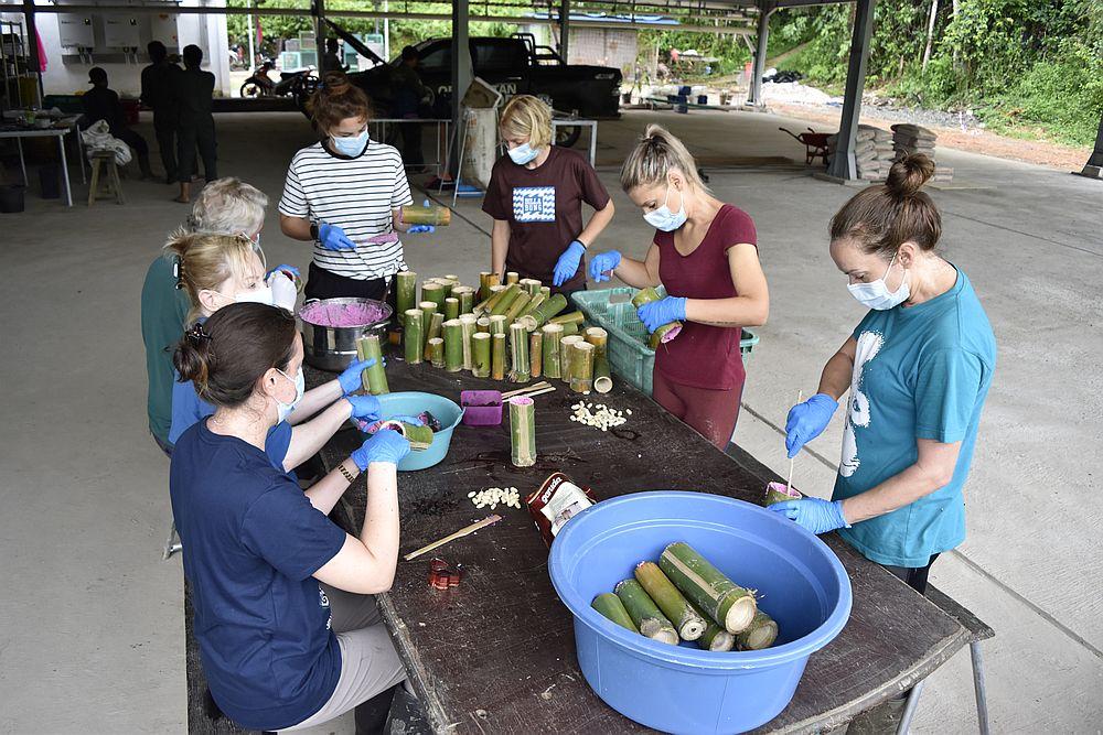 Volunteers creating bamboo enrichment for the orangutans
